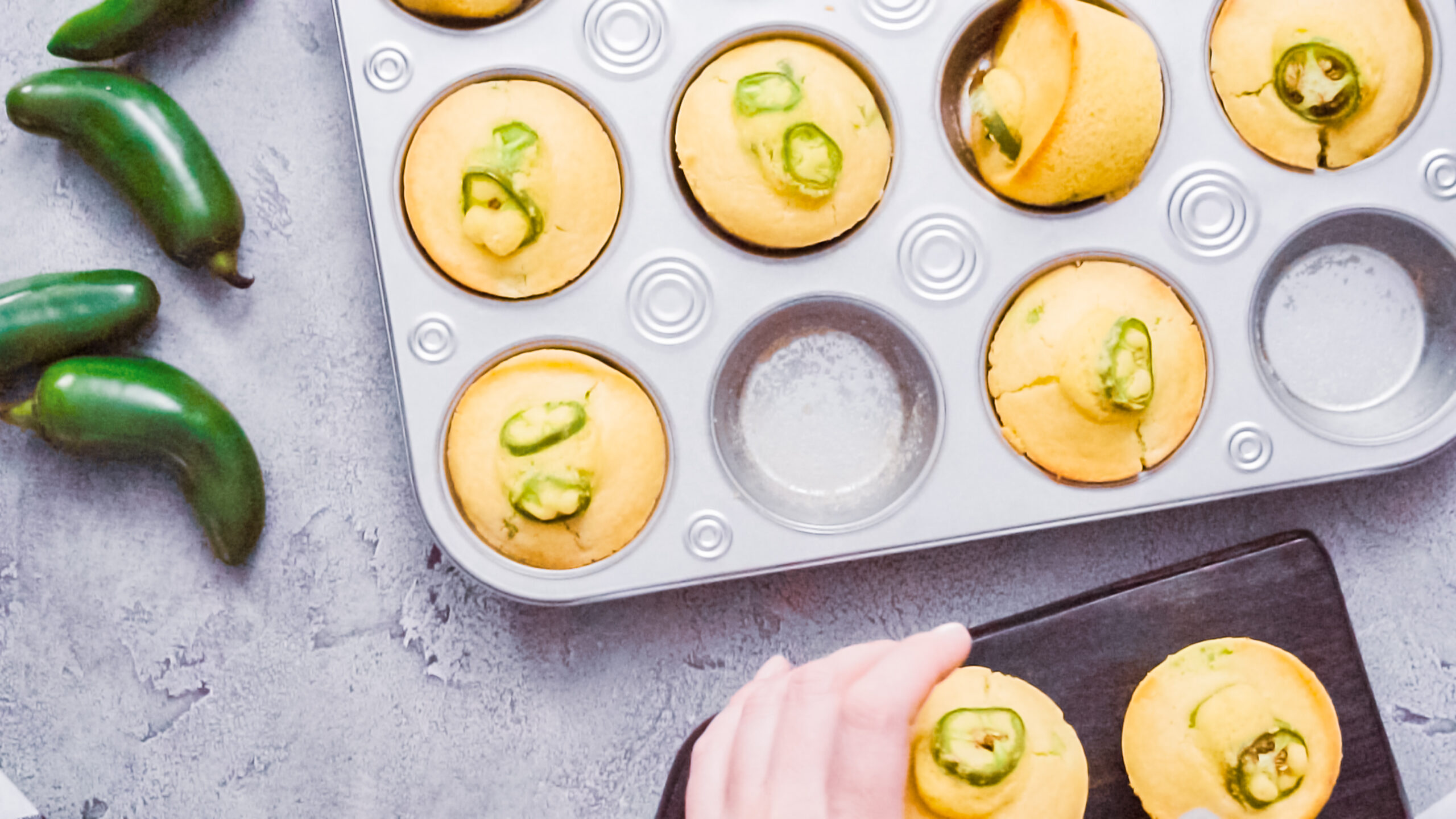 Spicy jalapeno cornbread muffins in wired basket.