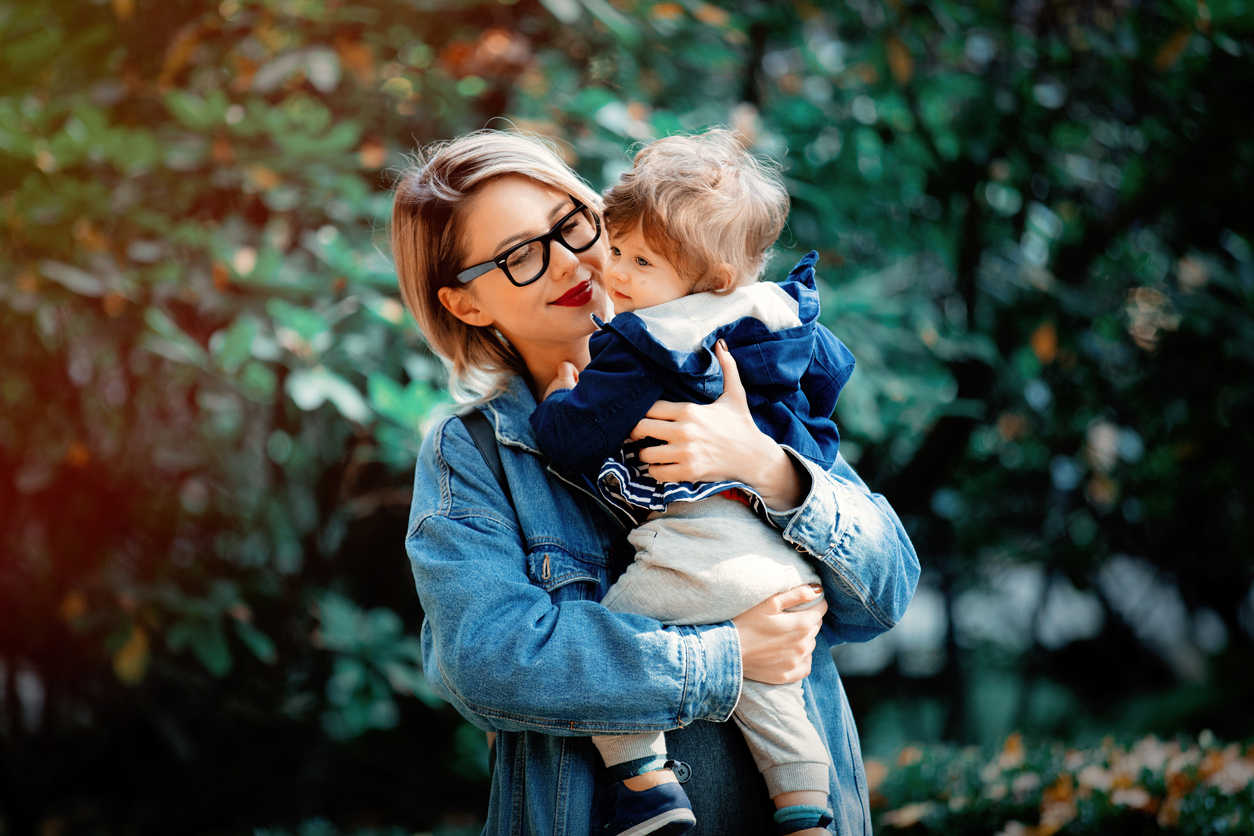 mother with a baby boy have a fun in a park