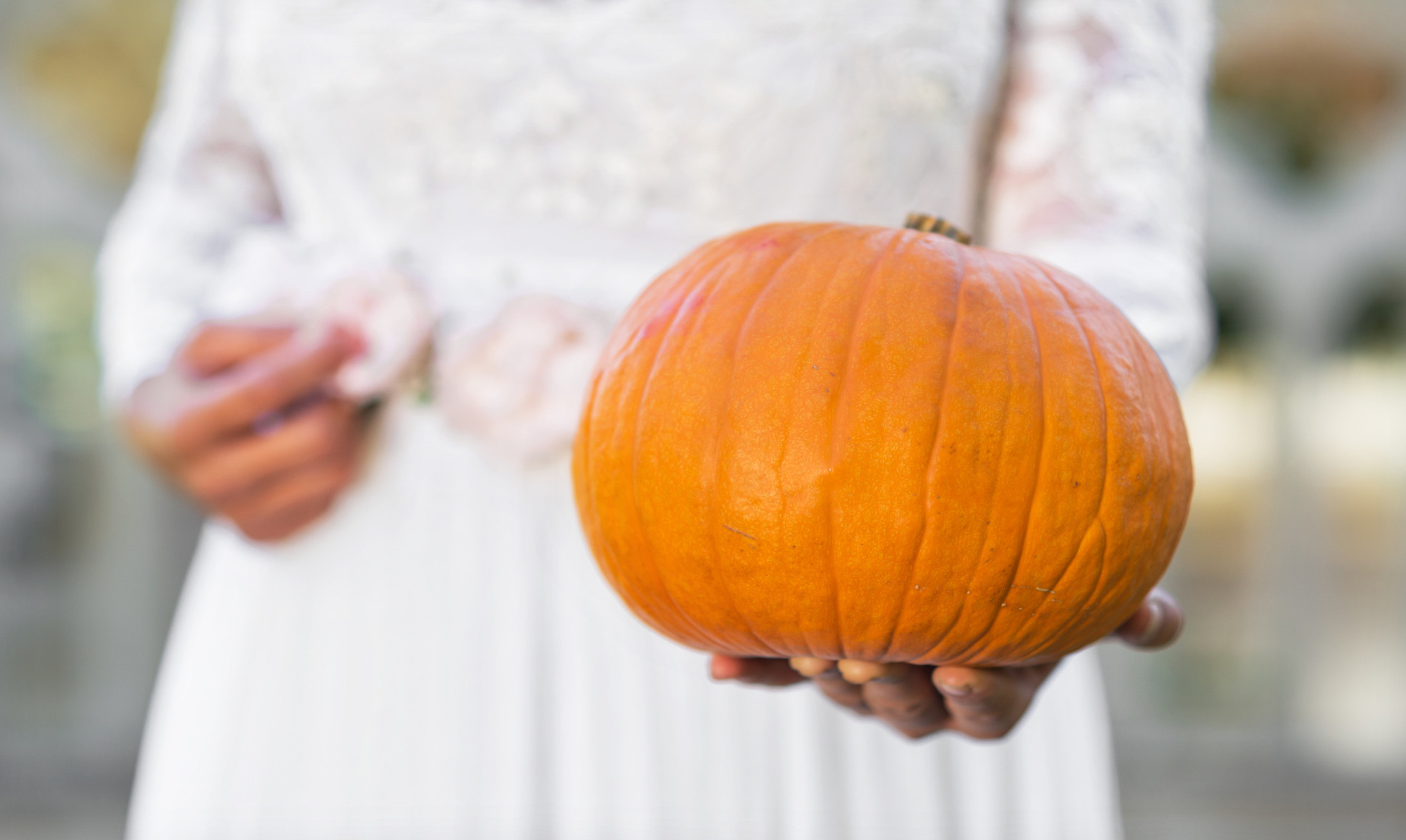 bride holding pumpkin