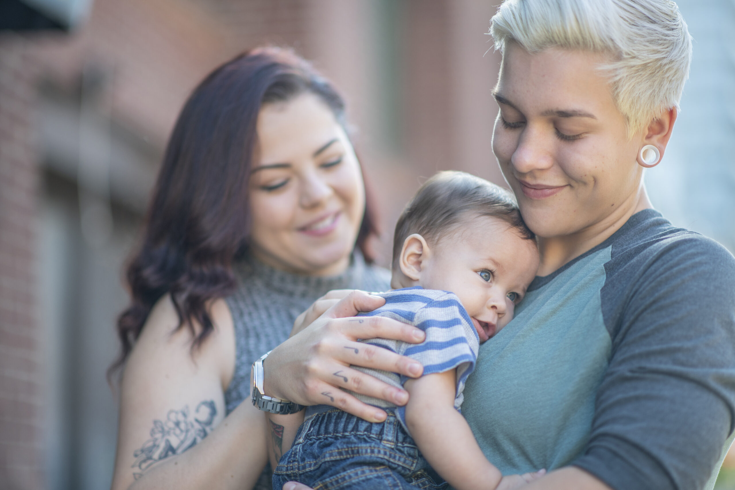 Same sex couple holding their baby