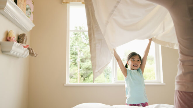 Daughter Making Bed Sheets