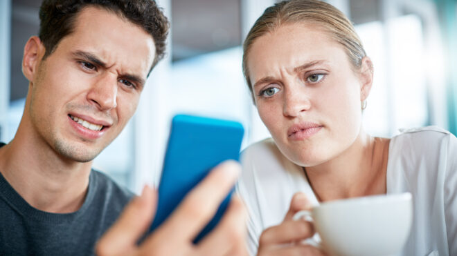 shocked couple looking at phone