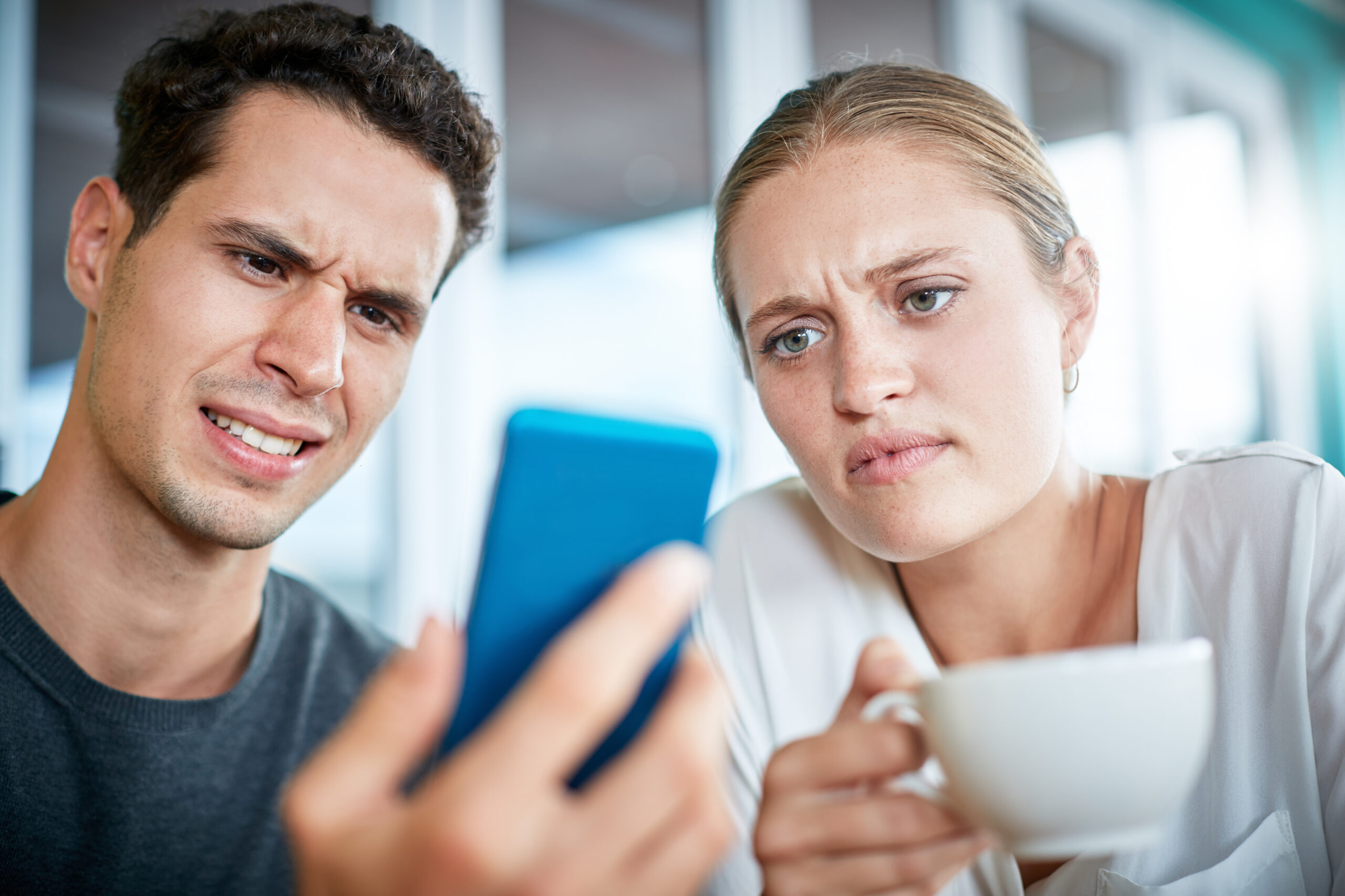 shocked couple looking at phone