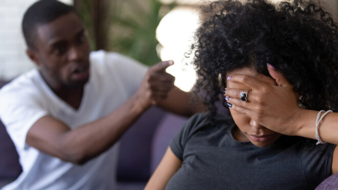 fighting couple with woman's hand covering her eyes