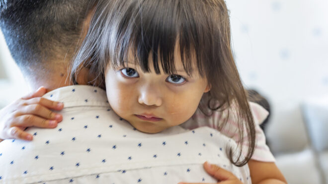 girl being hugged by dad