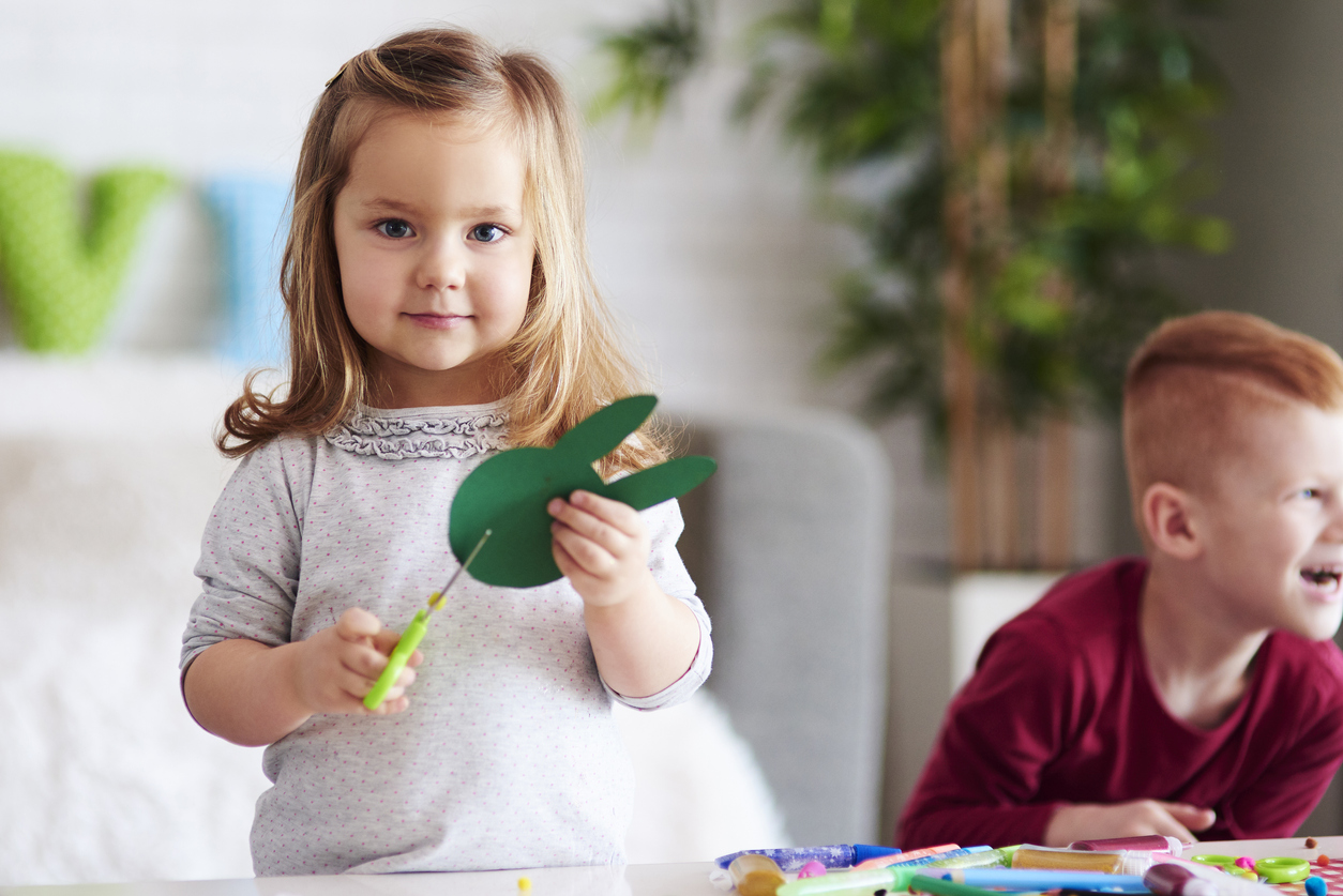 Cute girl preparing decorations for Easter