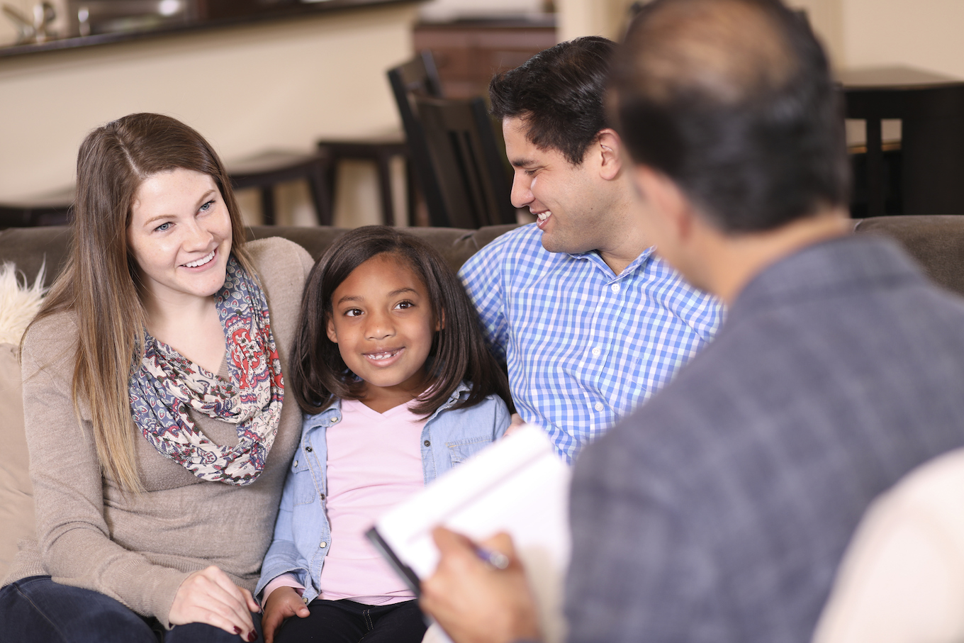 Family counseling session at home with therapist.