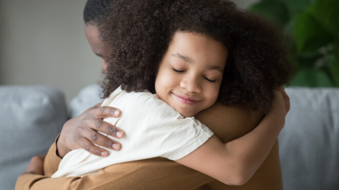 Child hugging parent