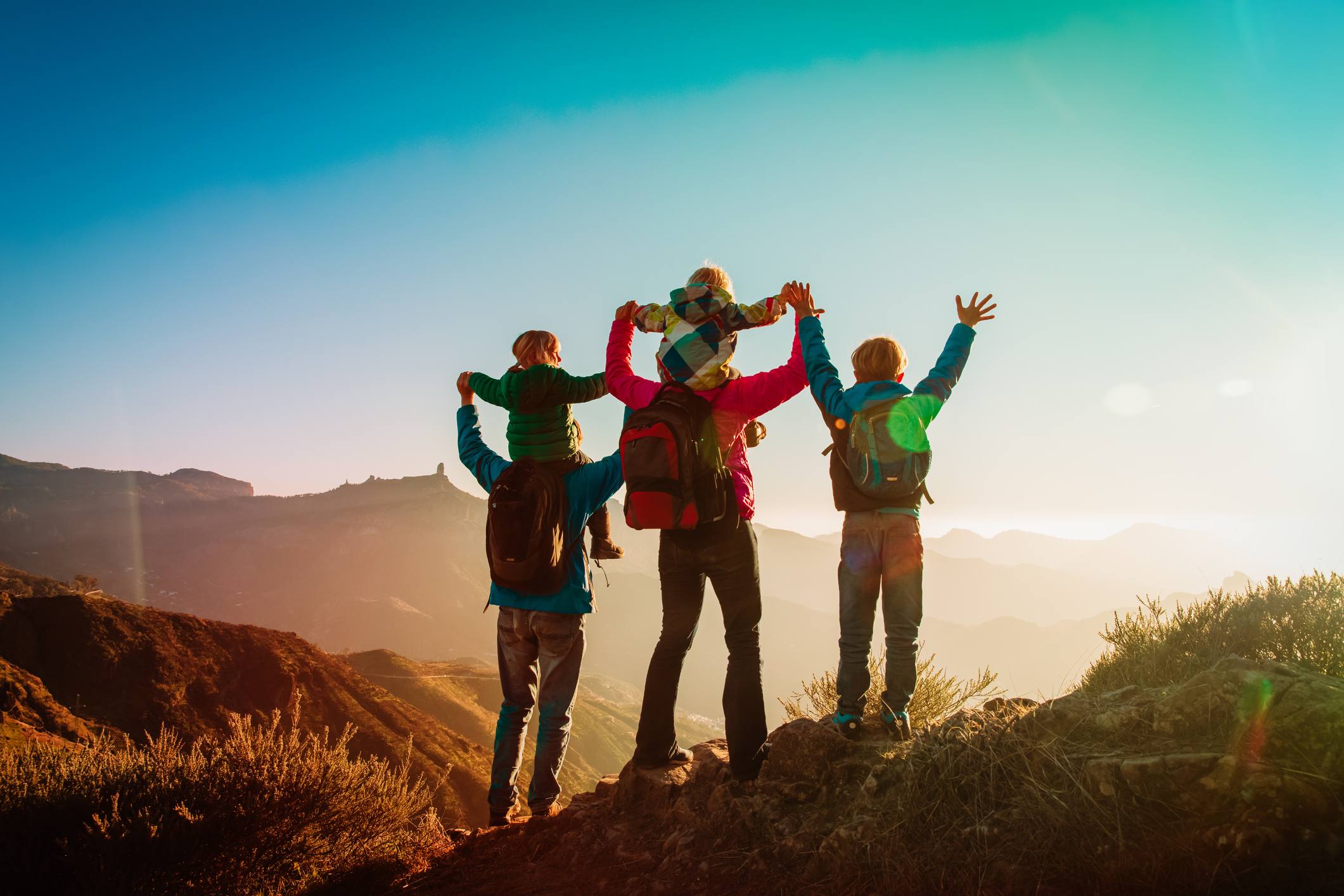 happy family travel in mountains at sunset