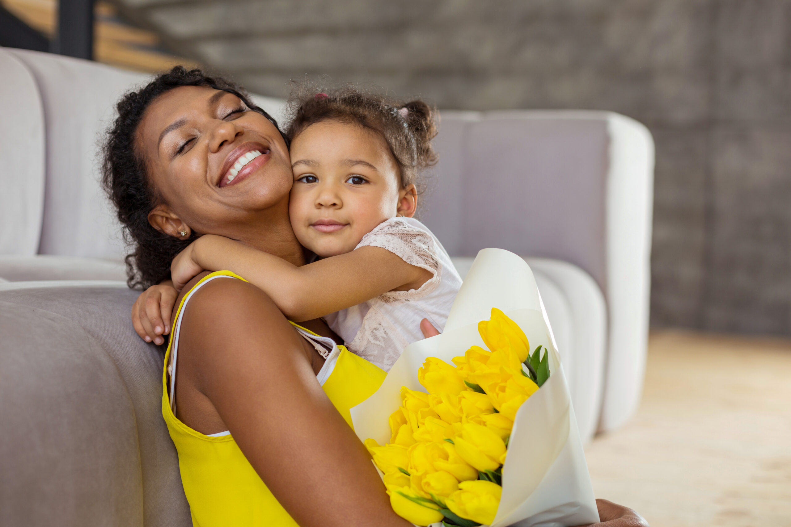 Attractive brunette girl caressing her young mother