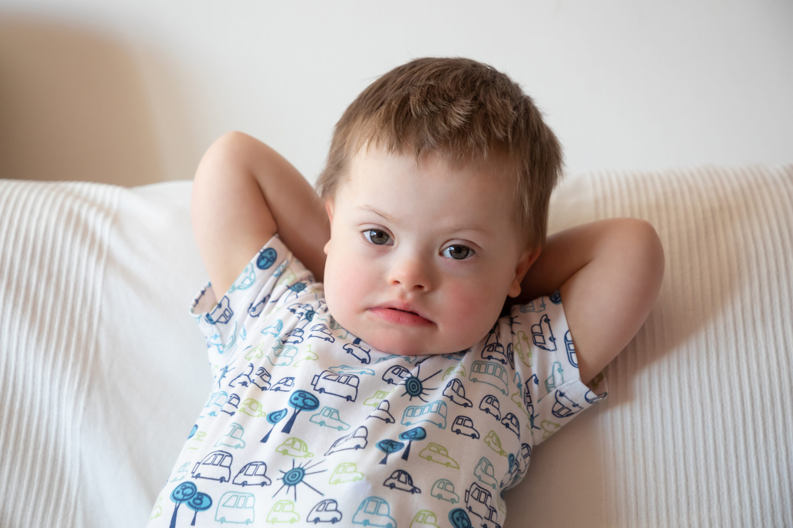 Portrait of cute small boy with Down syndrome