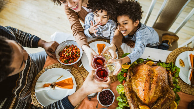 Family enjoying Thanksgiving cocktails during holiday dinner