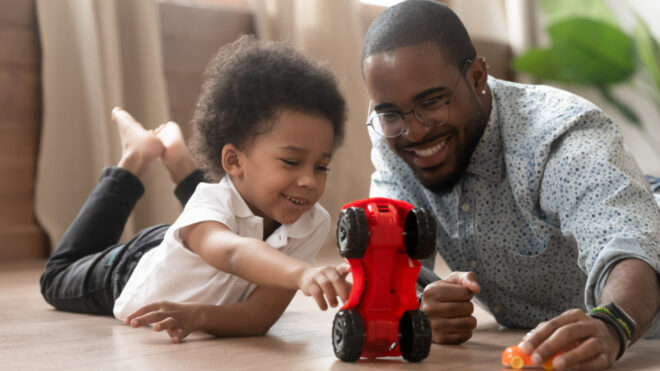 dad and son playing toy car