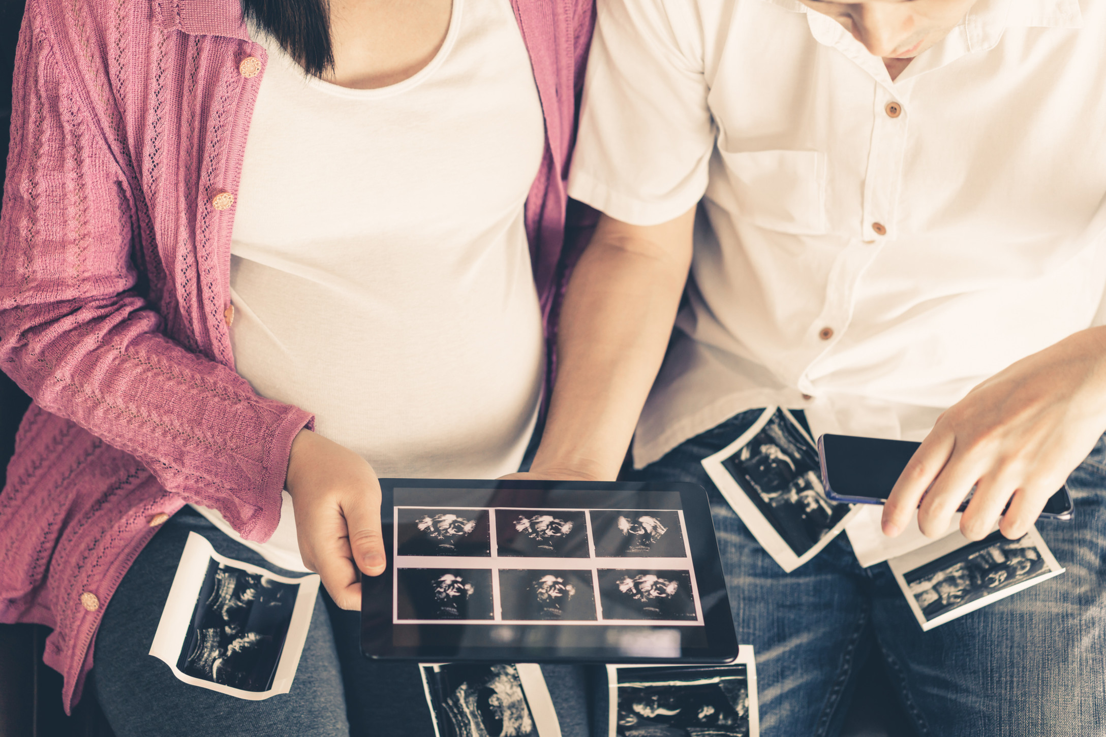 couple looks at sonogram