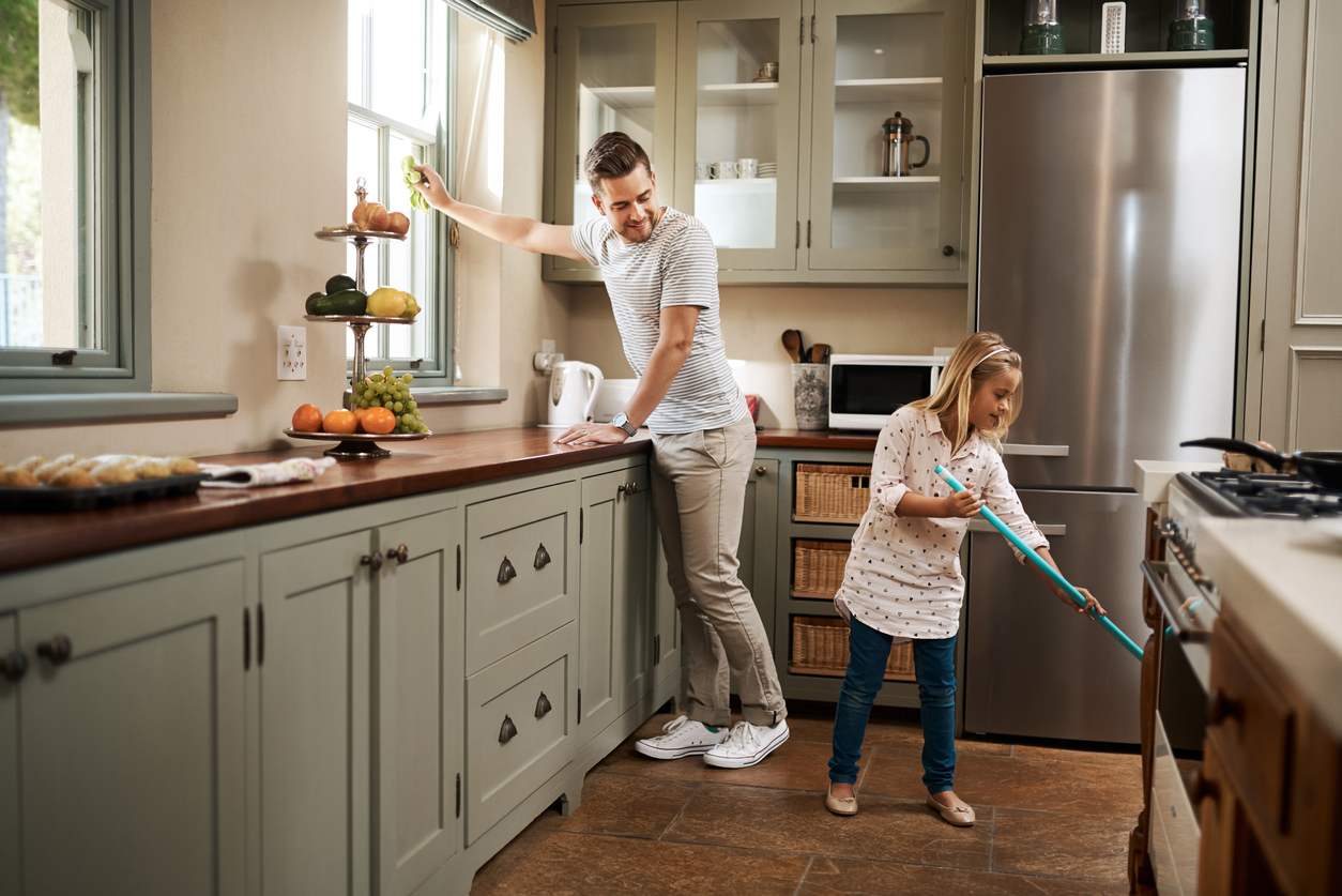 Dad and daughter cleaning kitchen