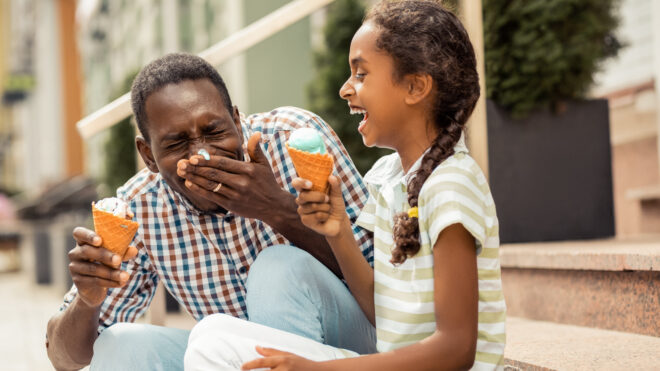 dad eating Ice cream with daughter