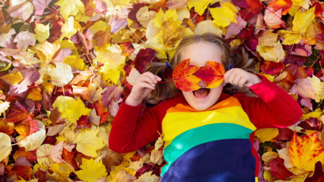 Girl in fall leaves