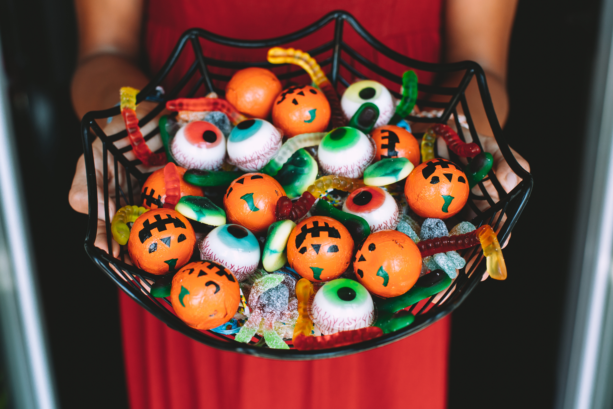 Woman offering funny Haloween candy at the front door