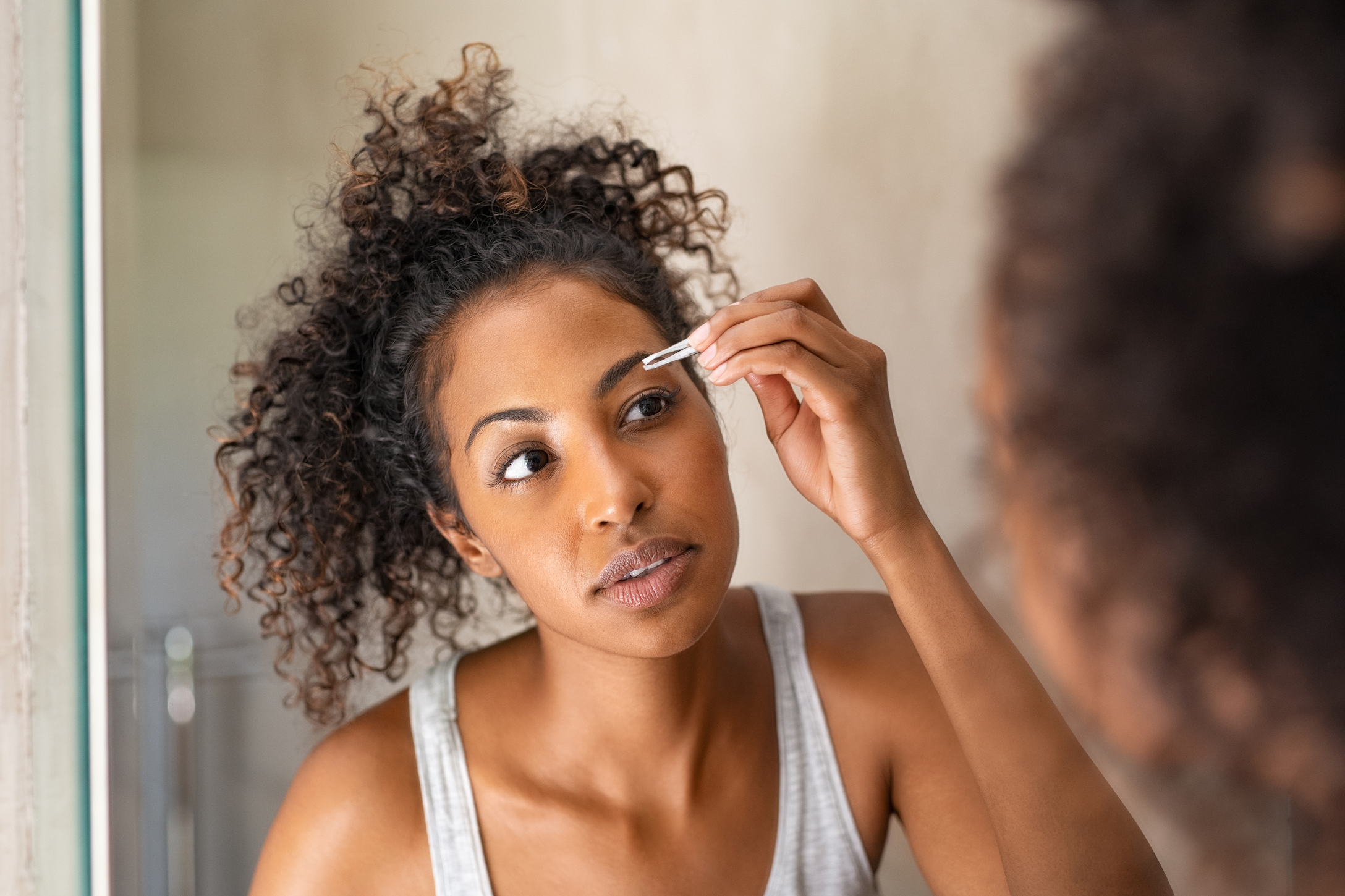 woman grooming eyebrow