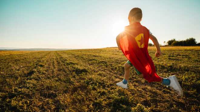 Imagination child running in superhero outfit