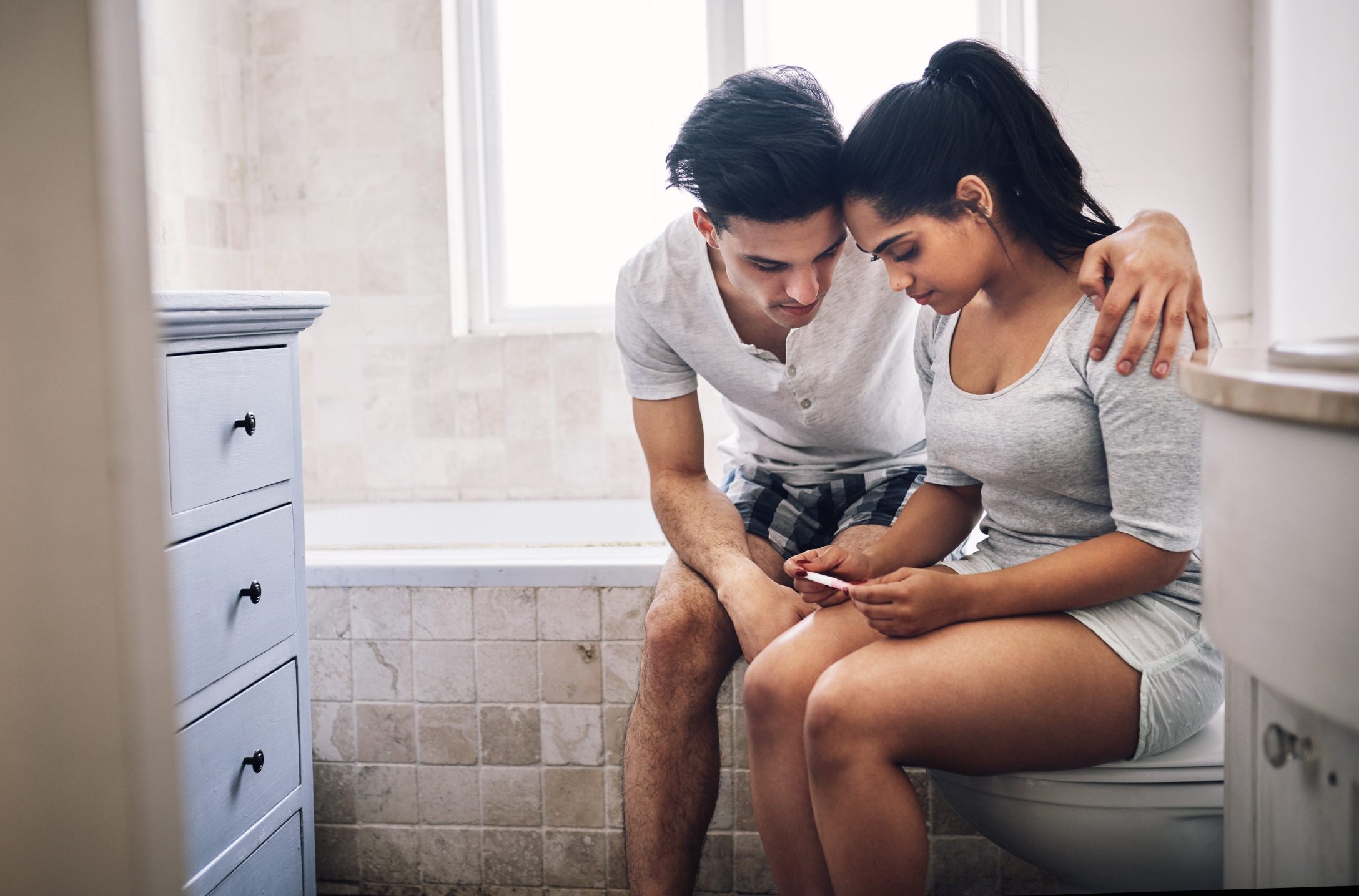 Boy and girl checking pregnancy test