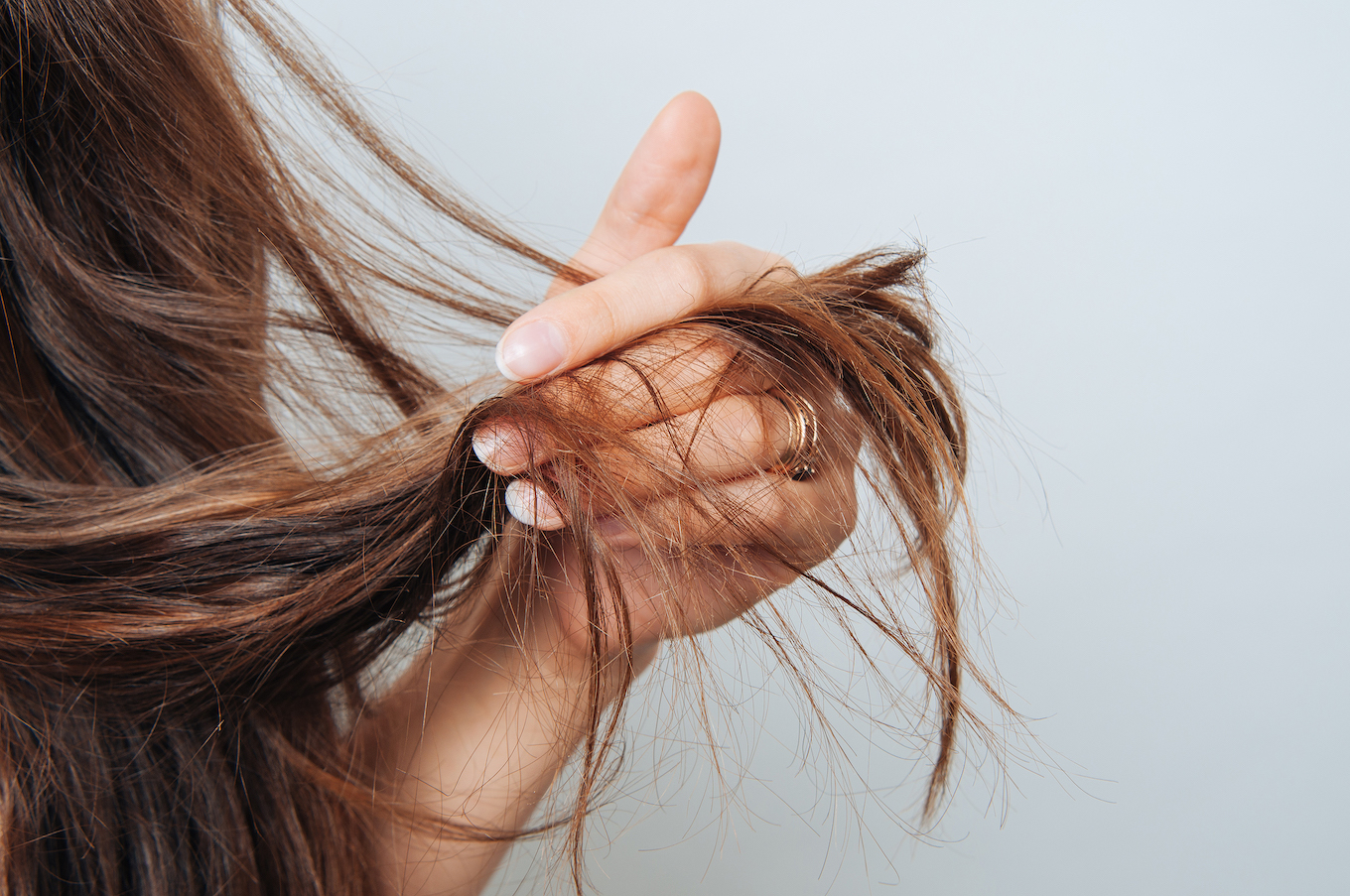 Girl holding her hair in her hand. Hair care concept. Shampoo. Haircut needed.