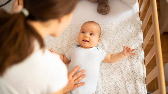 mom putting baby to bed