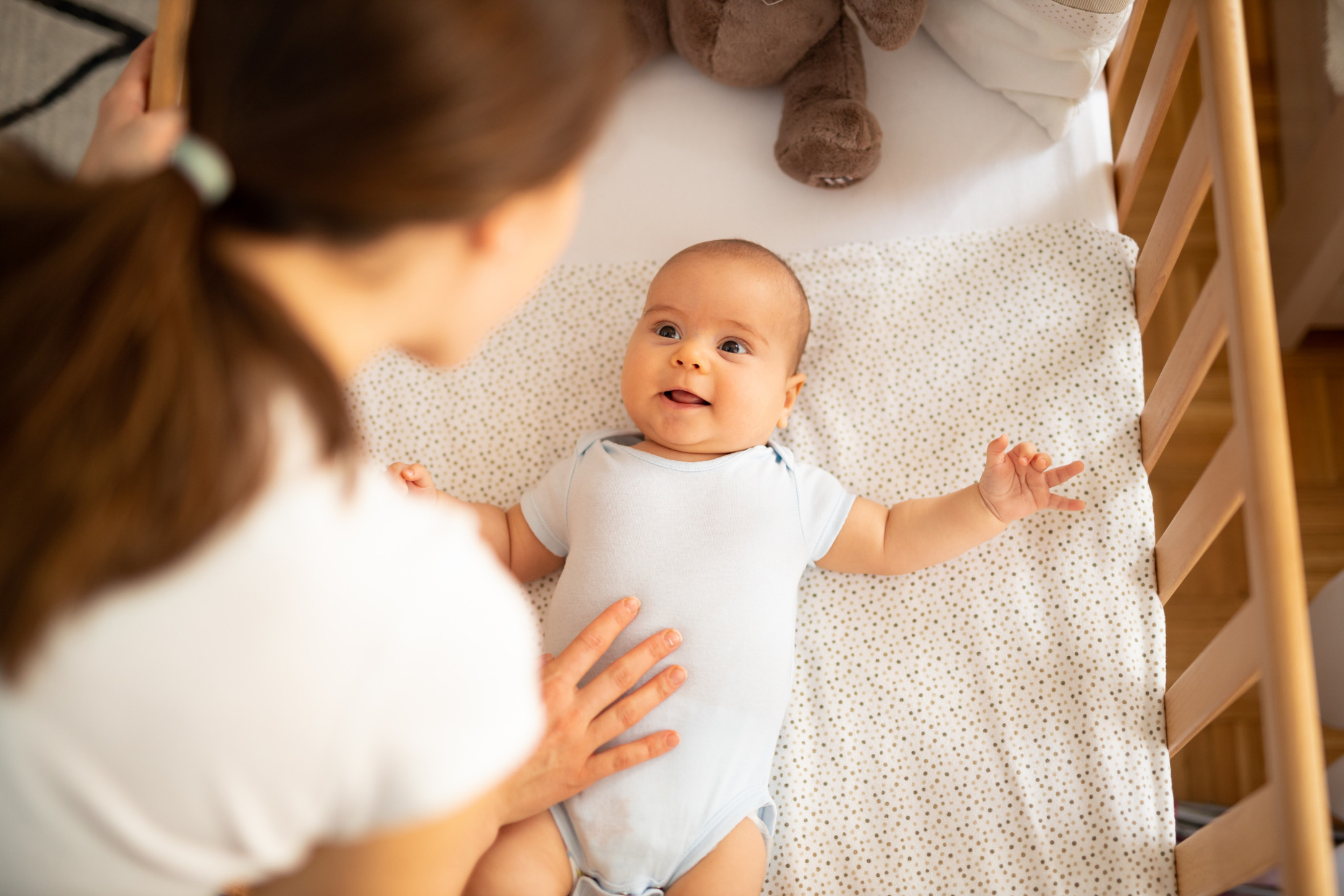 mom putting baby to bed