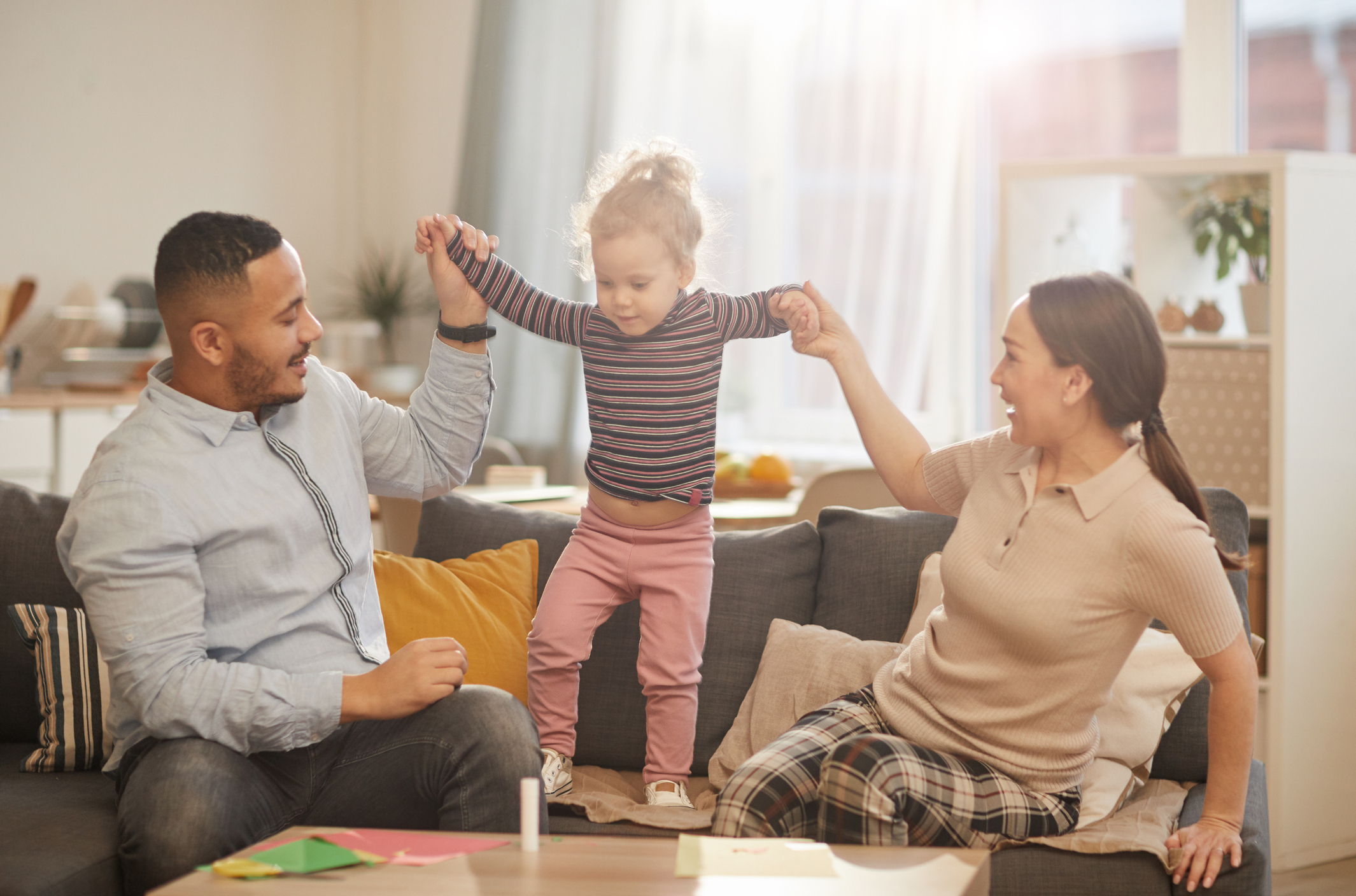 Happy Family Playing with Cute Little Daughter at Home