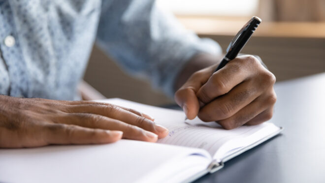 man writing a letter