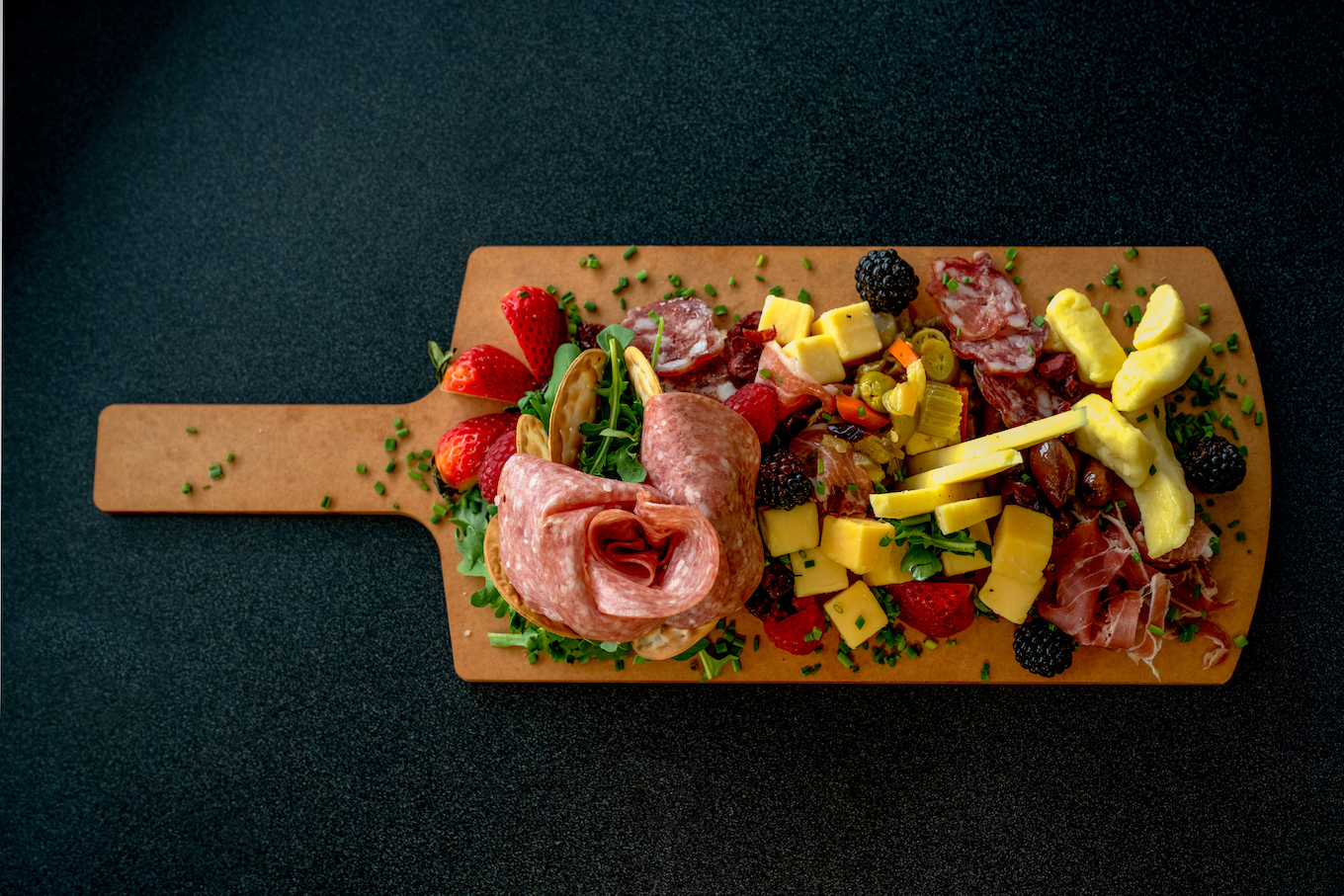 A Charcutierie Platter Arranged With A Variety Of Meats, Cheeses And Fruit