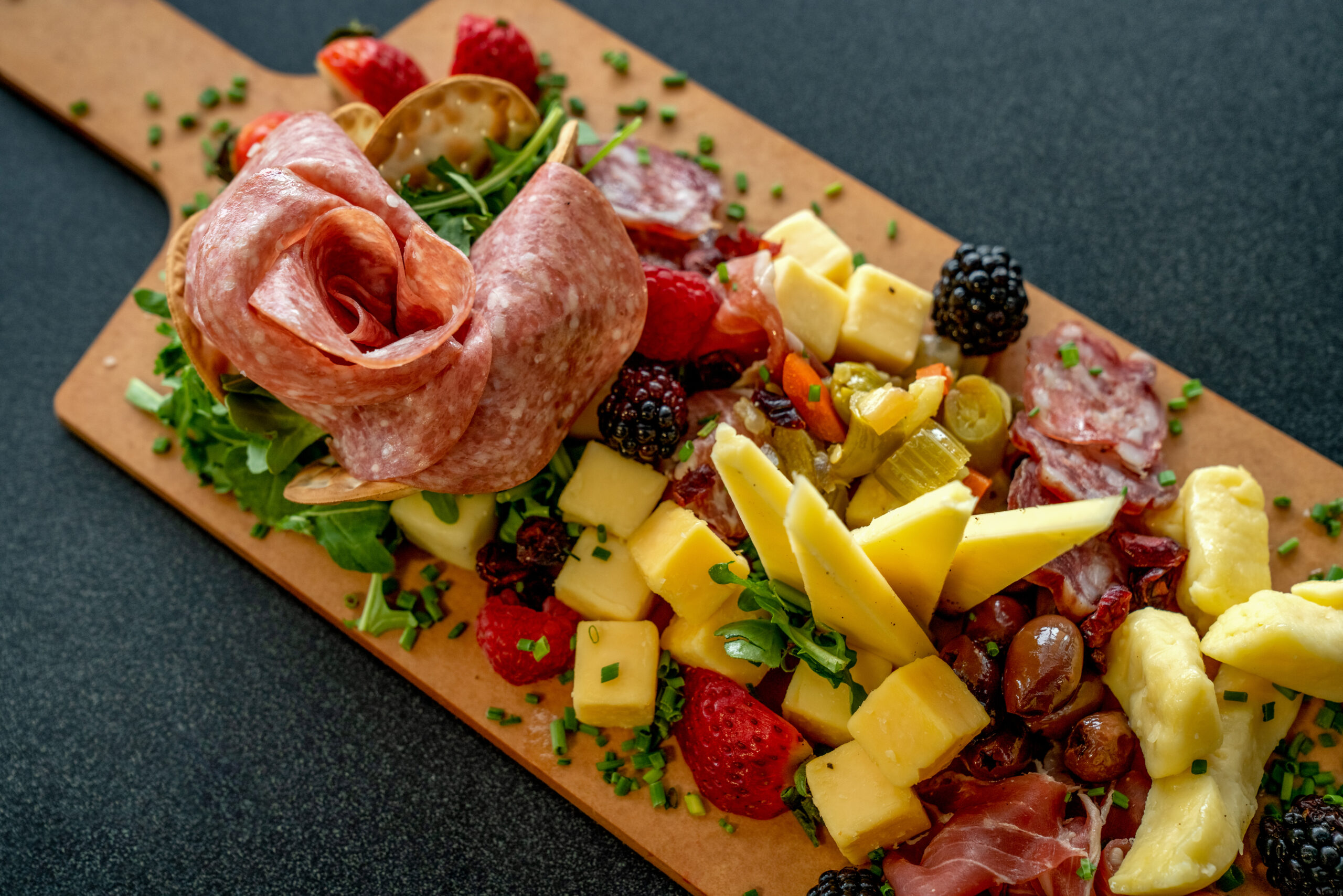 A Charcutierie Platter Arranged With A Variety Of Meats, Cheeses And Fruit