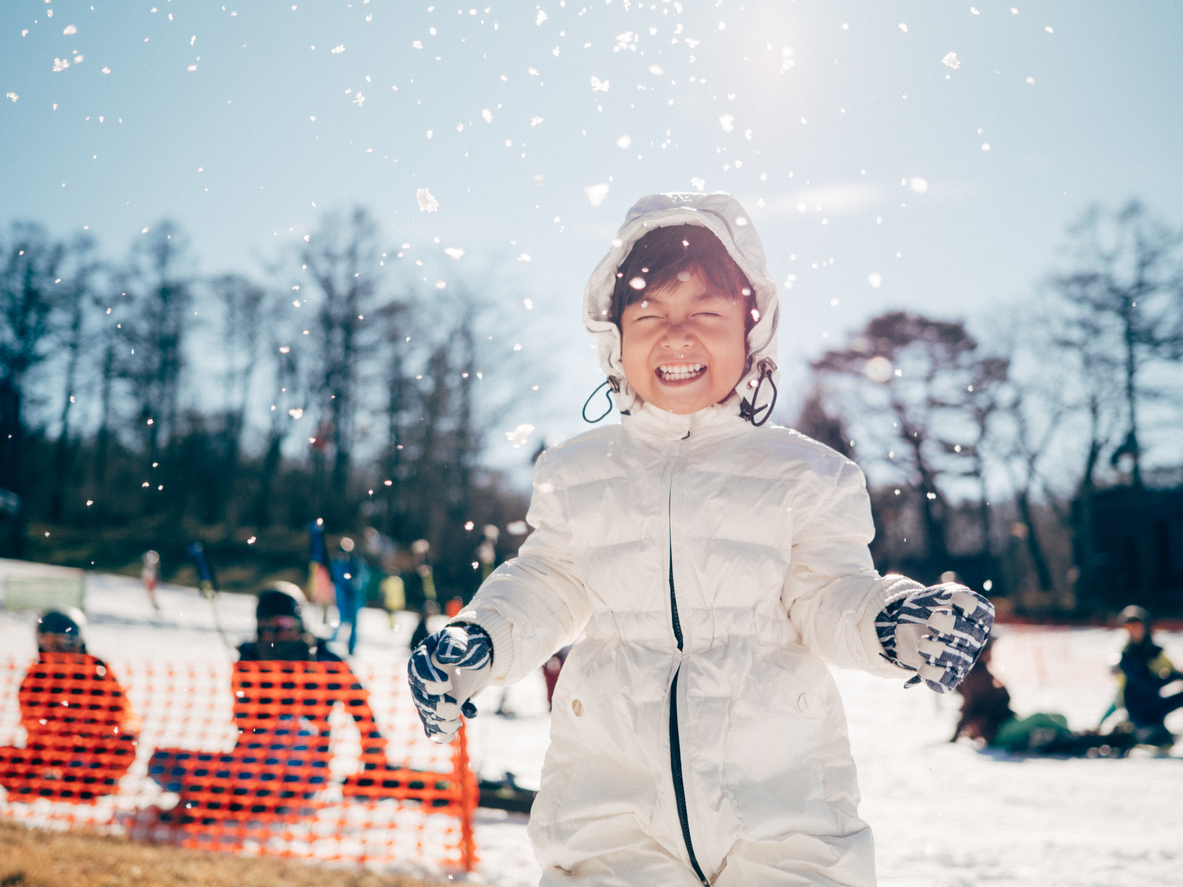 Cheerful child playing in the snow