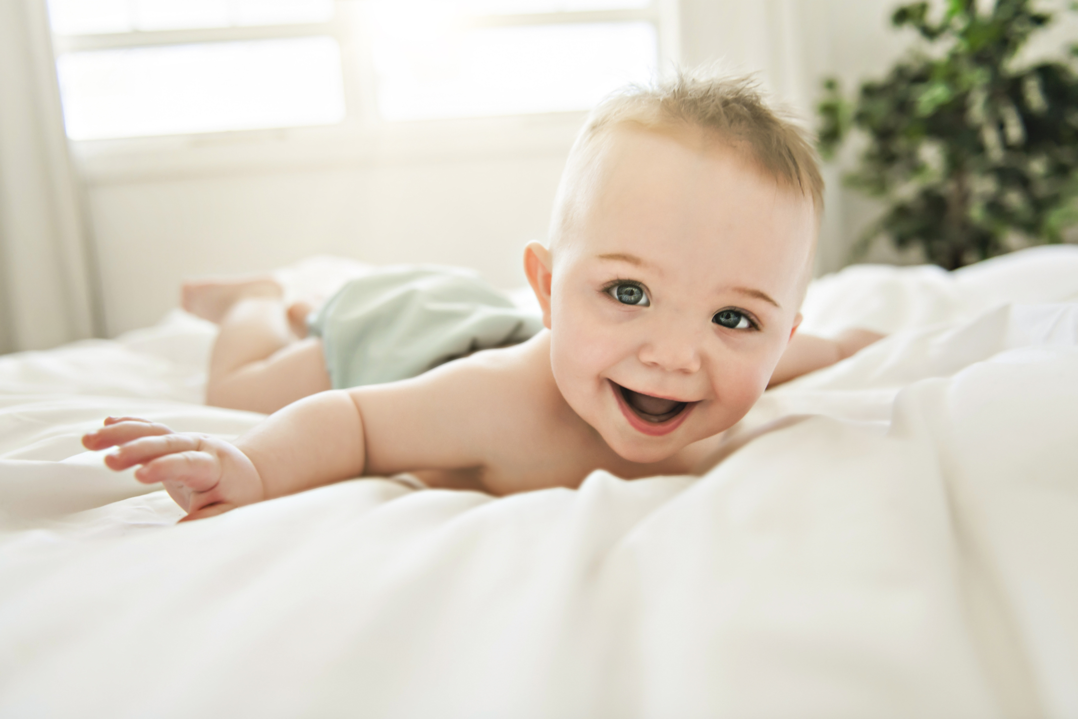 happy baby on bed