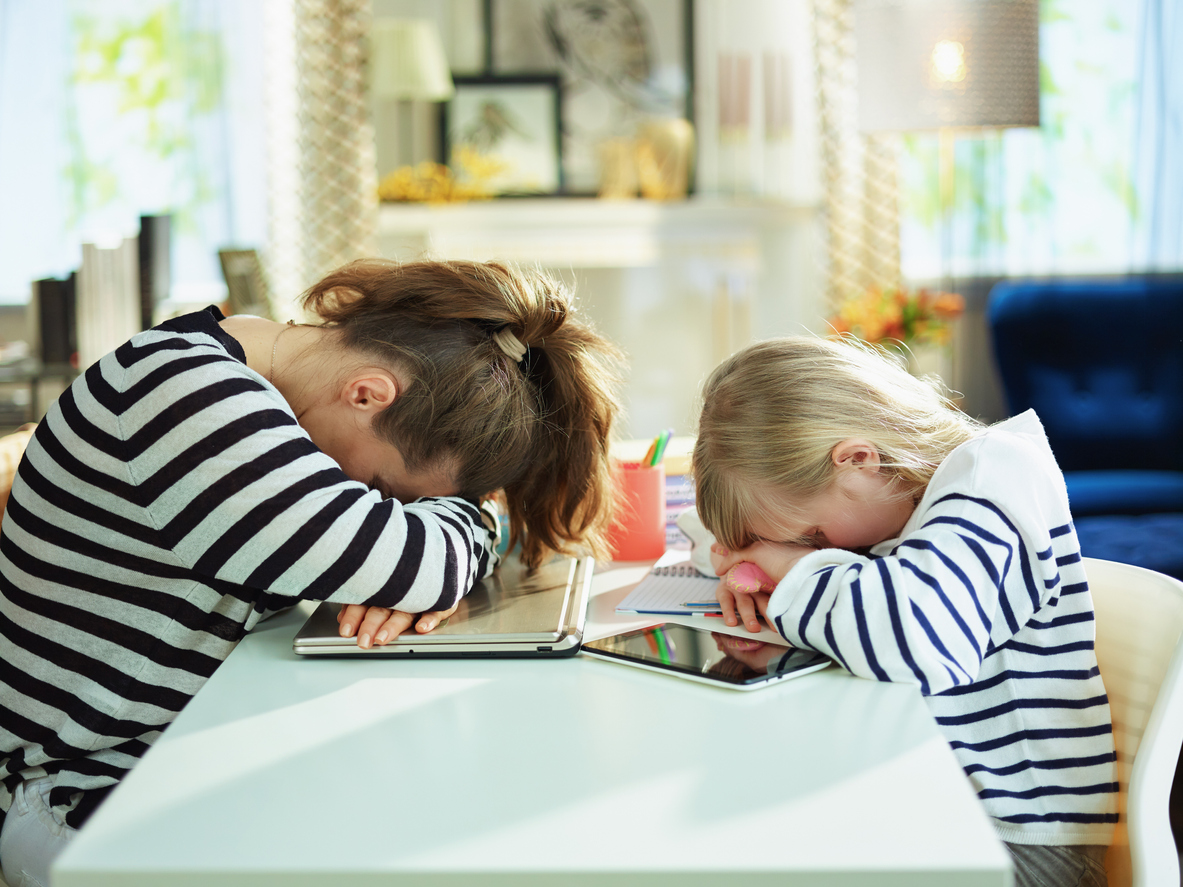 tired young mother and child laying on table