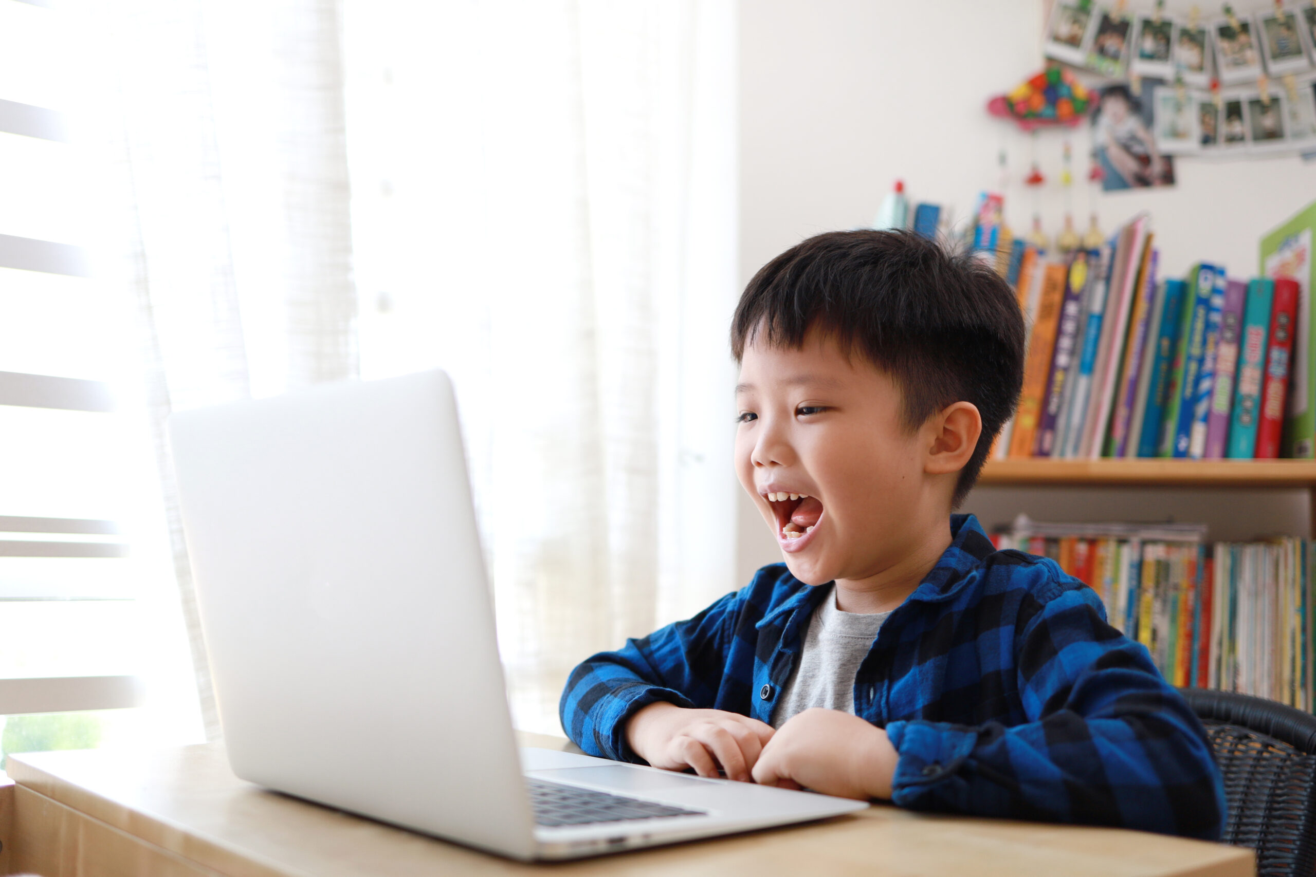 Boy using laptop for homework at home
