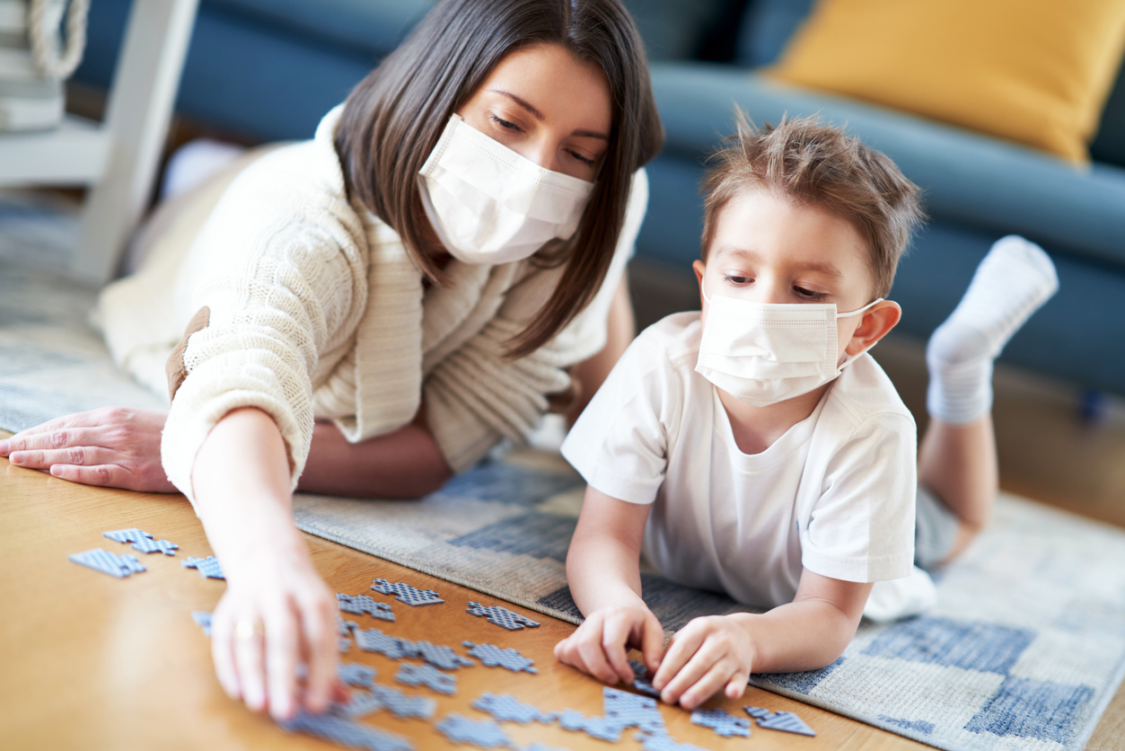 Mother and child playing together at home isolation during coronavirus pandemic