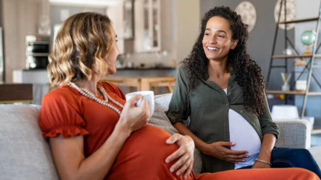 two pregnant women talking