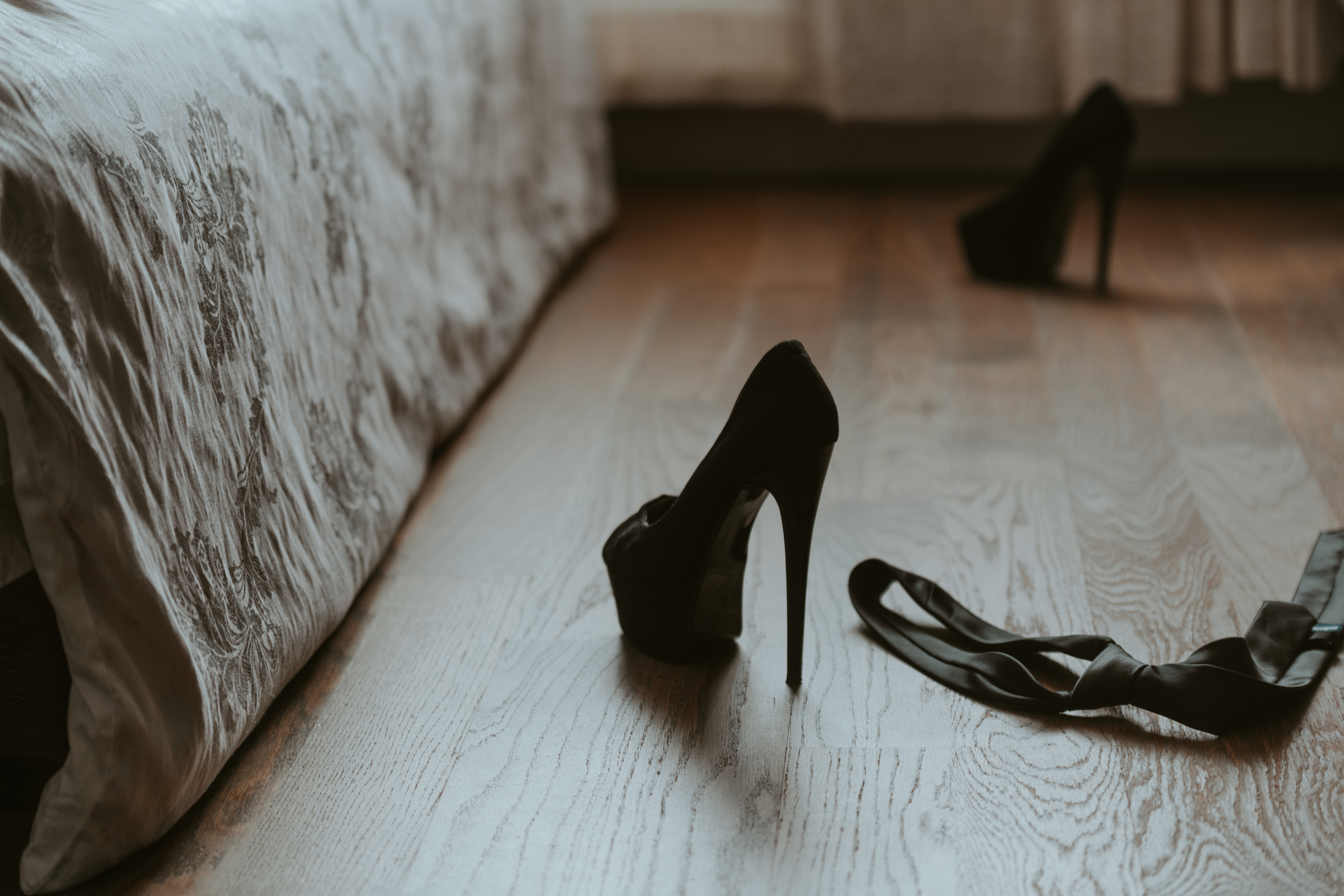 mess in bedroom after sex. woman's and man's clothes scattered in bedroom. morning after dating. quick sex, couple in love, honey month.