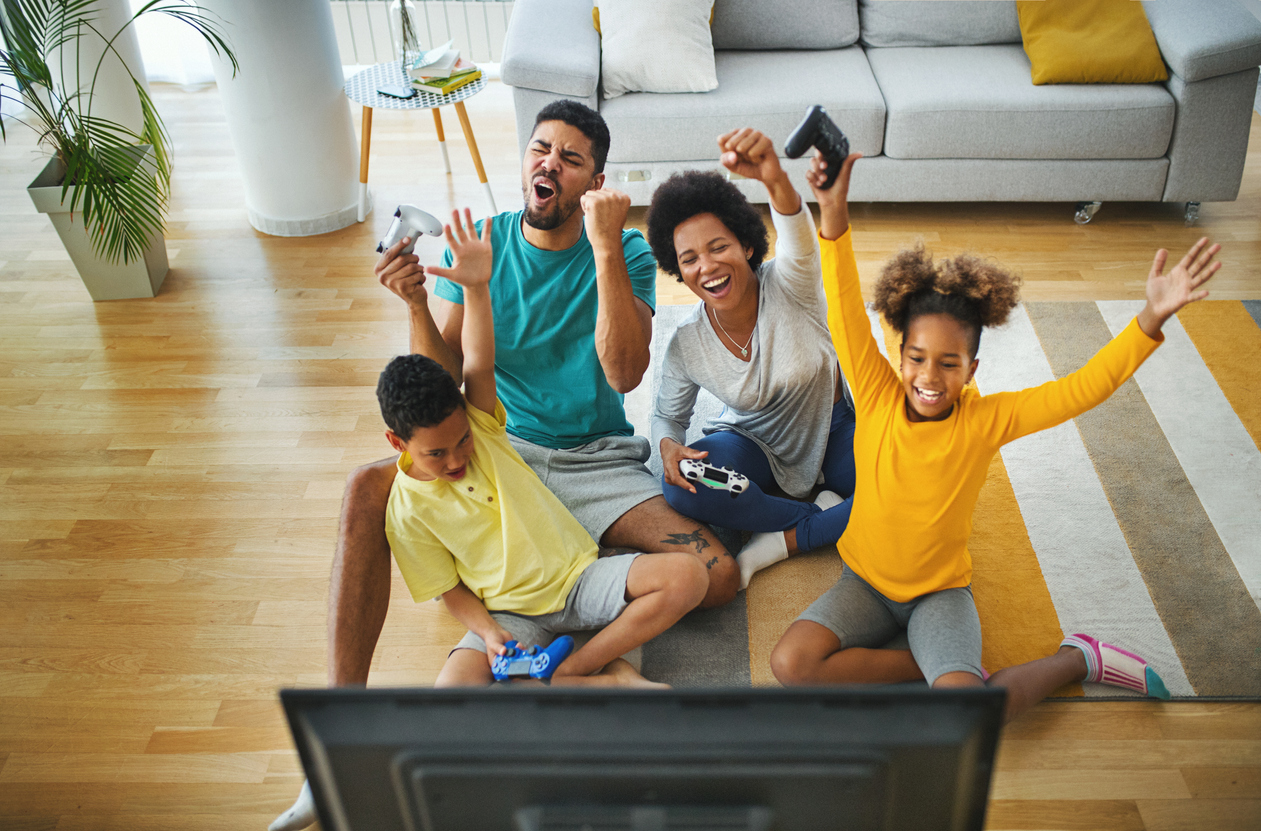 Family playing video games at home during coronavirus quarantine.
