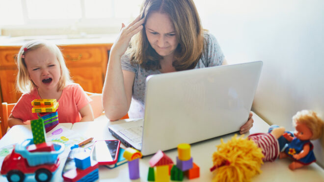 mom on laptop while toddler screams