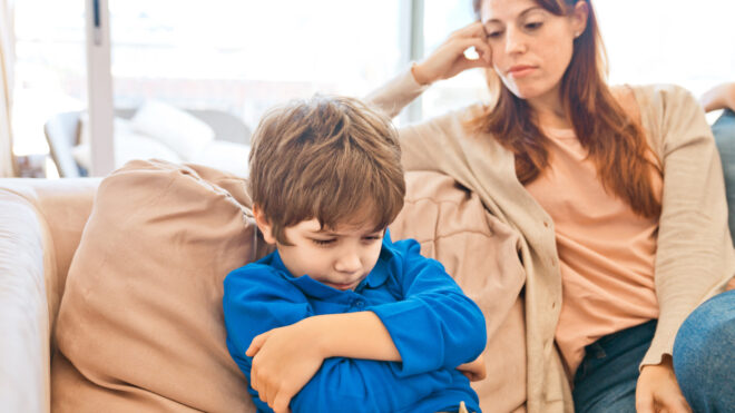 Stepmom arguing with stepson on couch