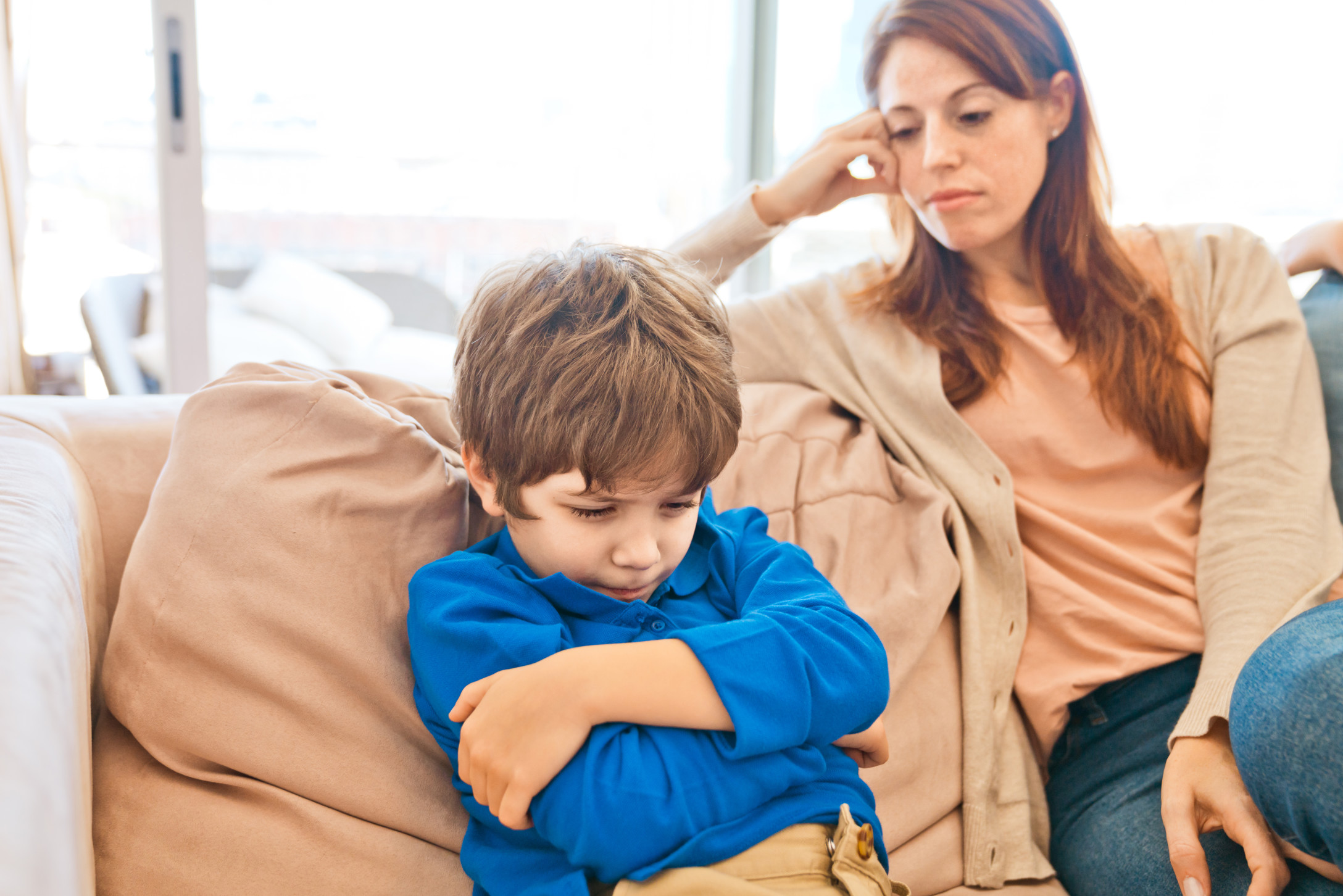 Stepmom arguing with stepson on couch