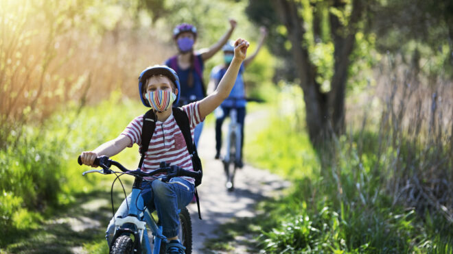 Mom and kids bike riding in spring