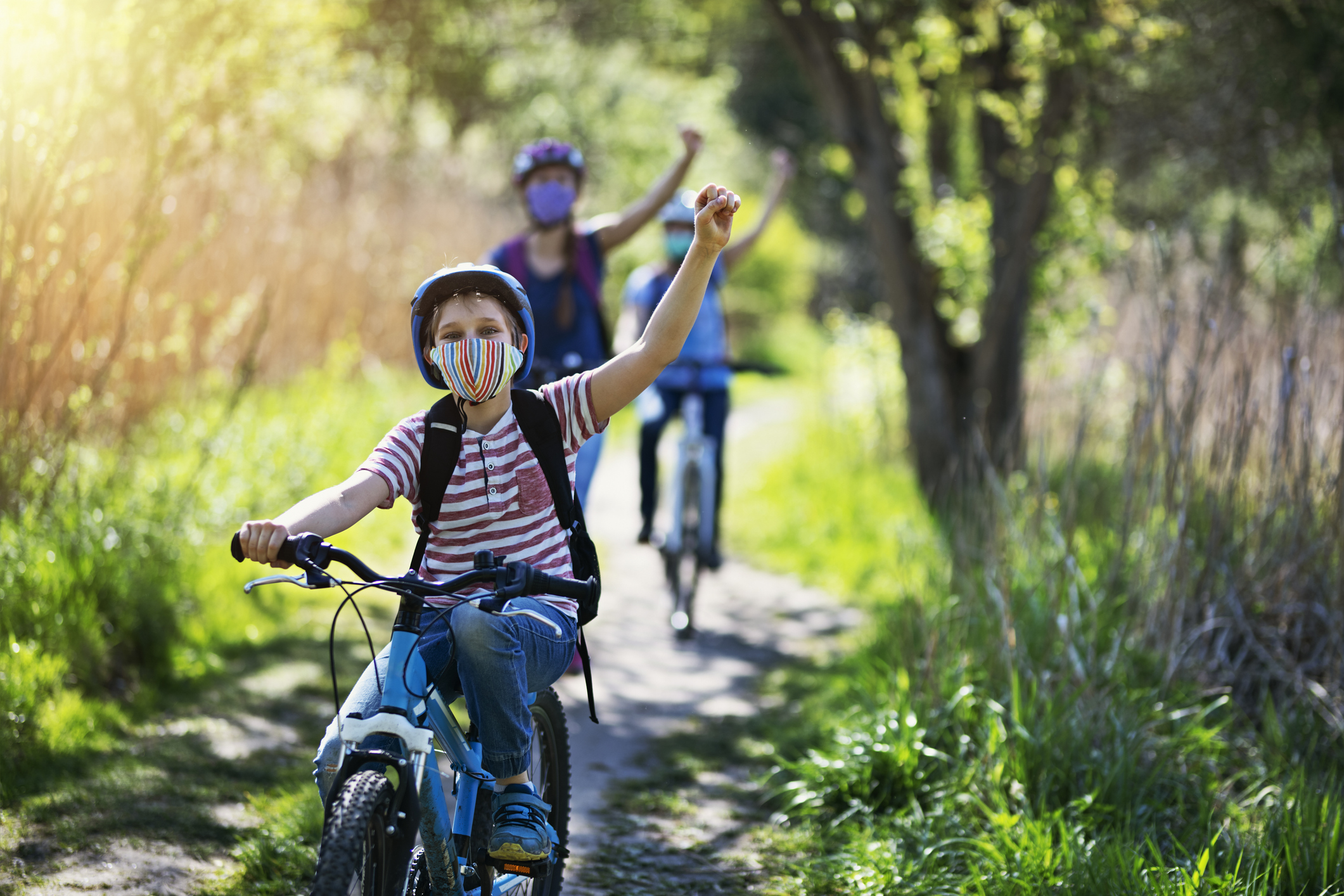 Mom and kids bike riding in spring