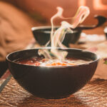 Hot vegetable soup in a dish made of natural materials. Traditional family lunch in a Russian village