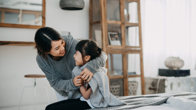 asian mom hugging daughter