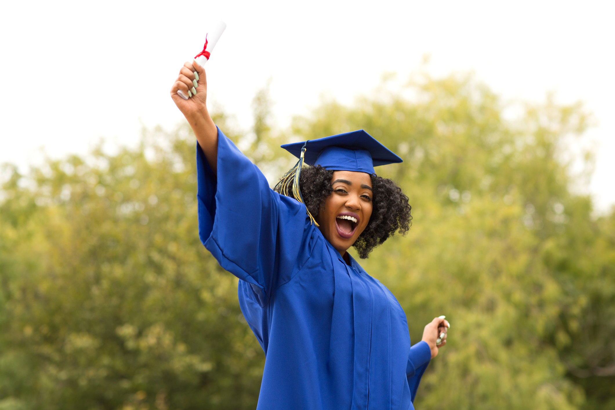 Excited young woman on graduation day.