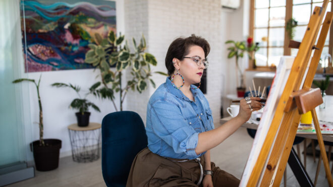 stock image of plus-size-woman painting