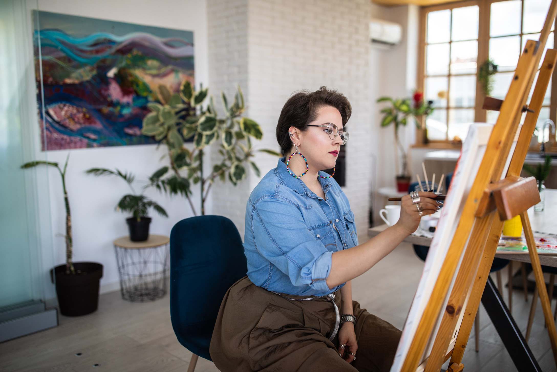 stock image of plus-size-woman painting